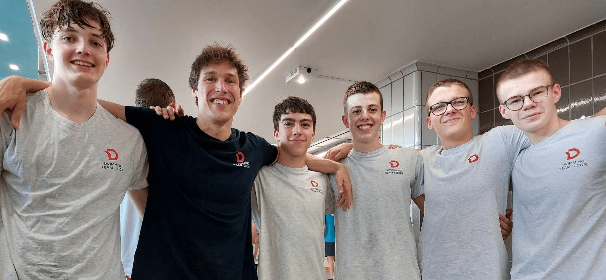 Modern home office setup with a monitor, ergonomic chair, keyboard, and indoor plants near a window with blinds.