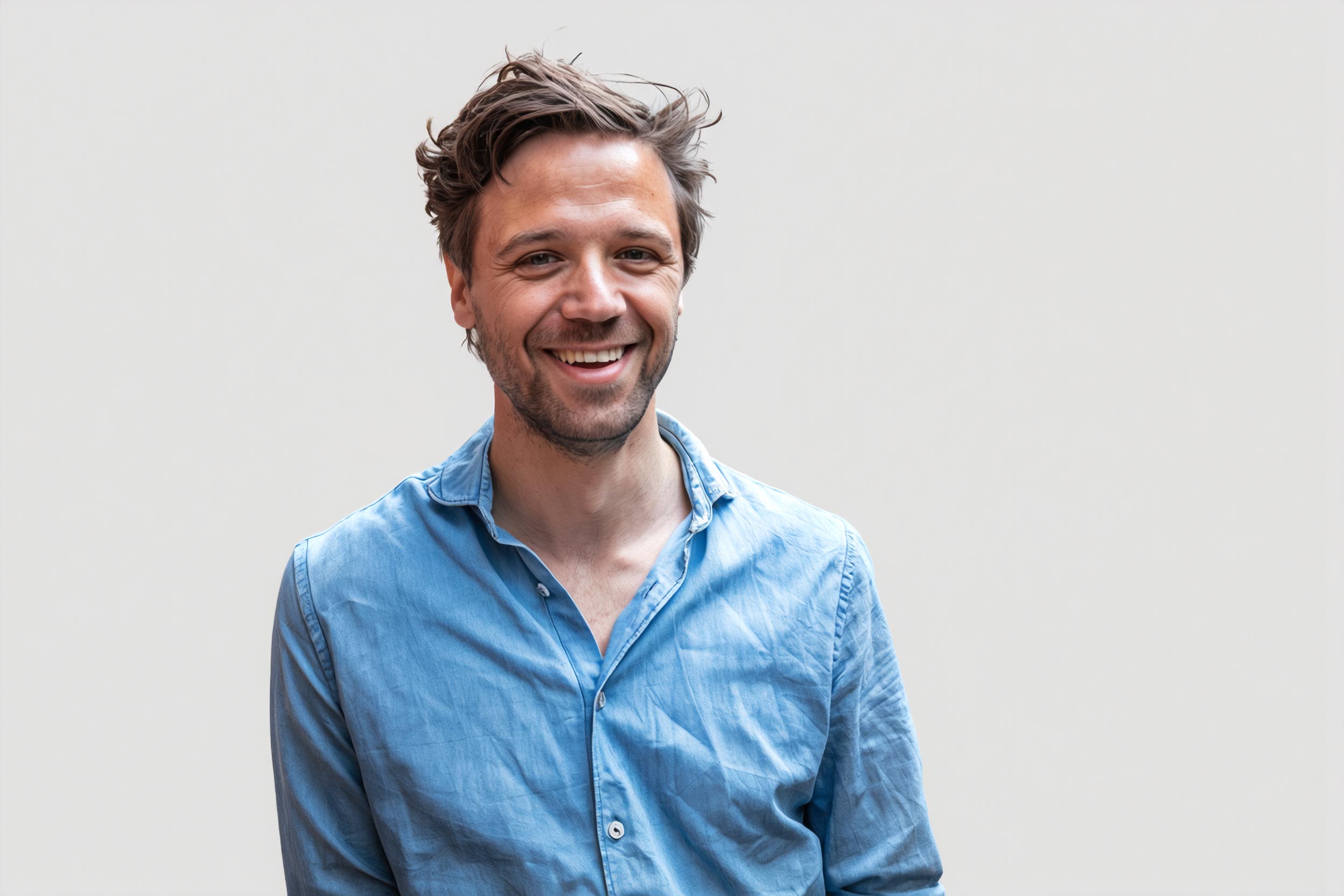 Portrait of a person in a pink sweater against a light background