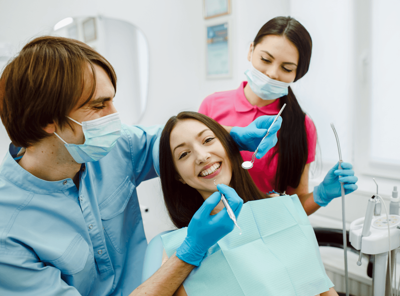 A dentist and a female patient sharing a laugh in the dental clinic, creating a relaxed and friendly atmosphere