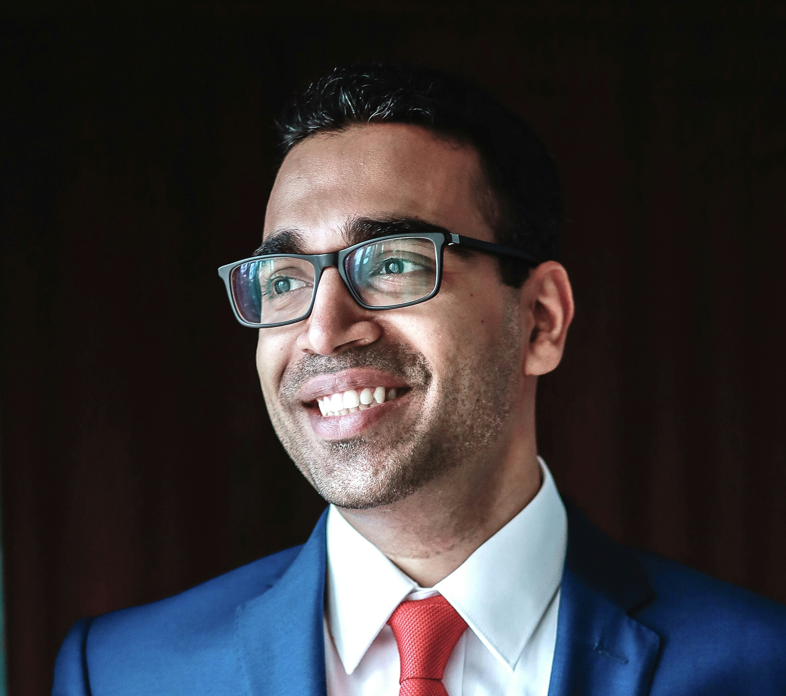 Man in suit and glasses smiling