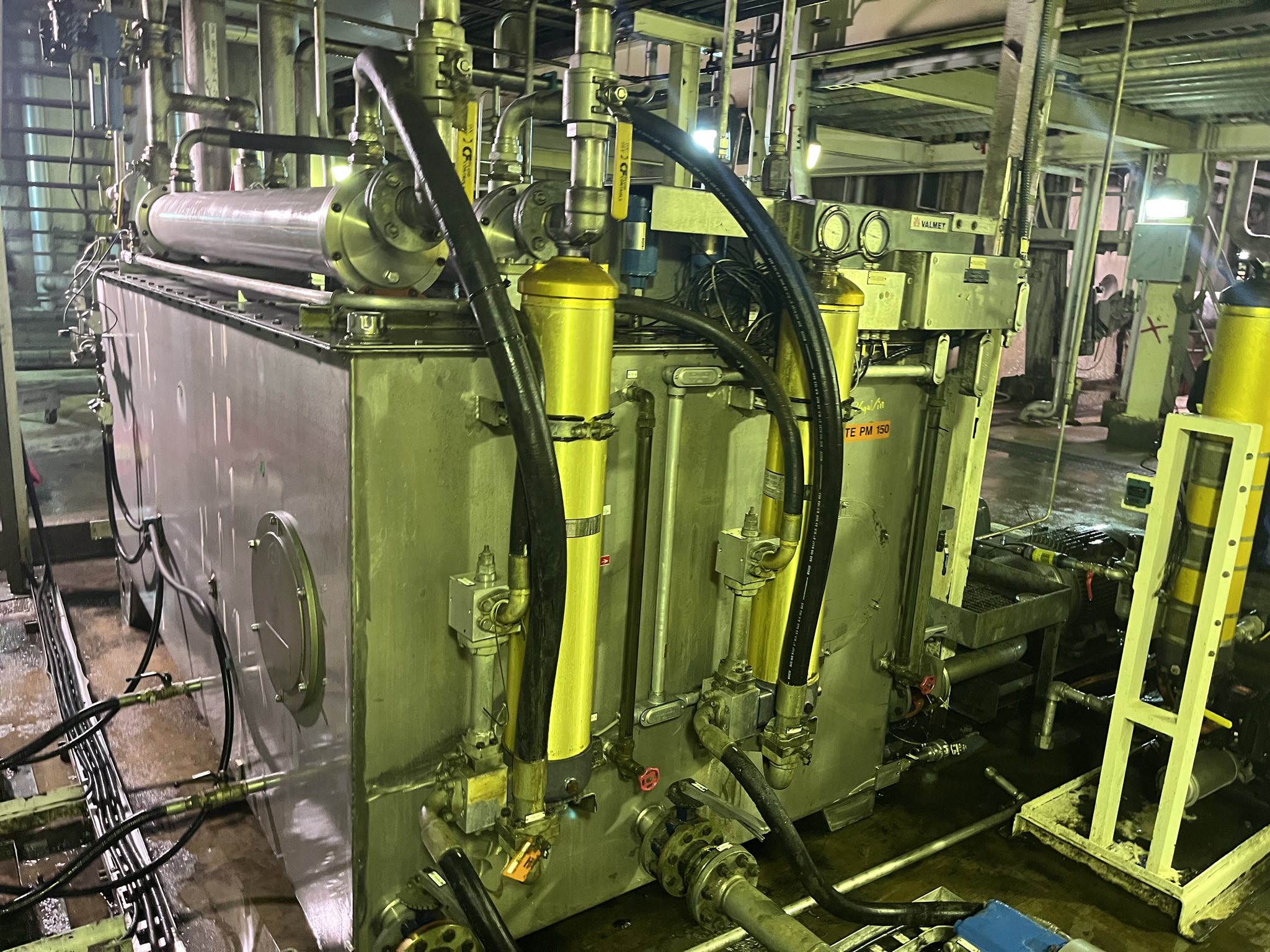 Hydraulic system panel with hoses, gauges, and fluid reservoirs for mechanical power transmission