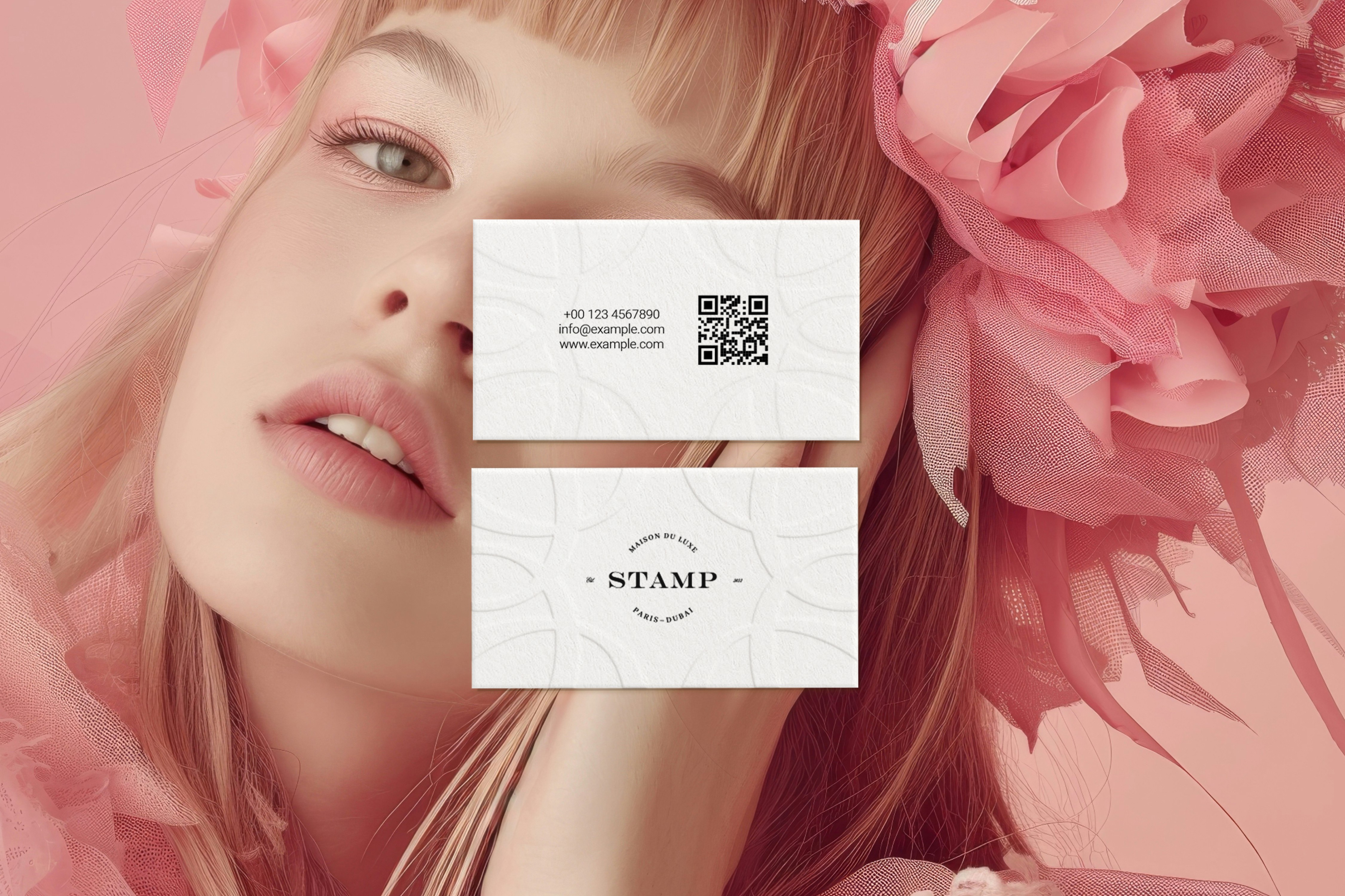 A luxurious business card design for STAMP, displayed in an elegant setting with a model in soft pink florals.