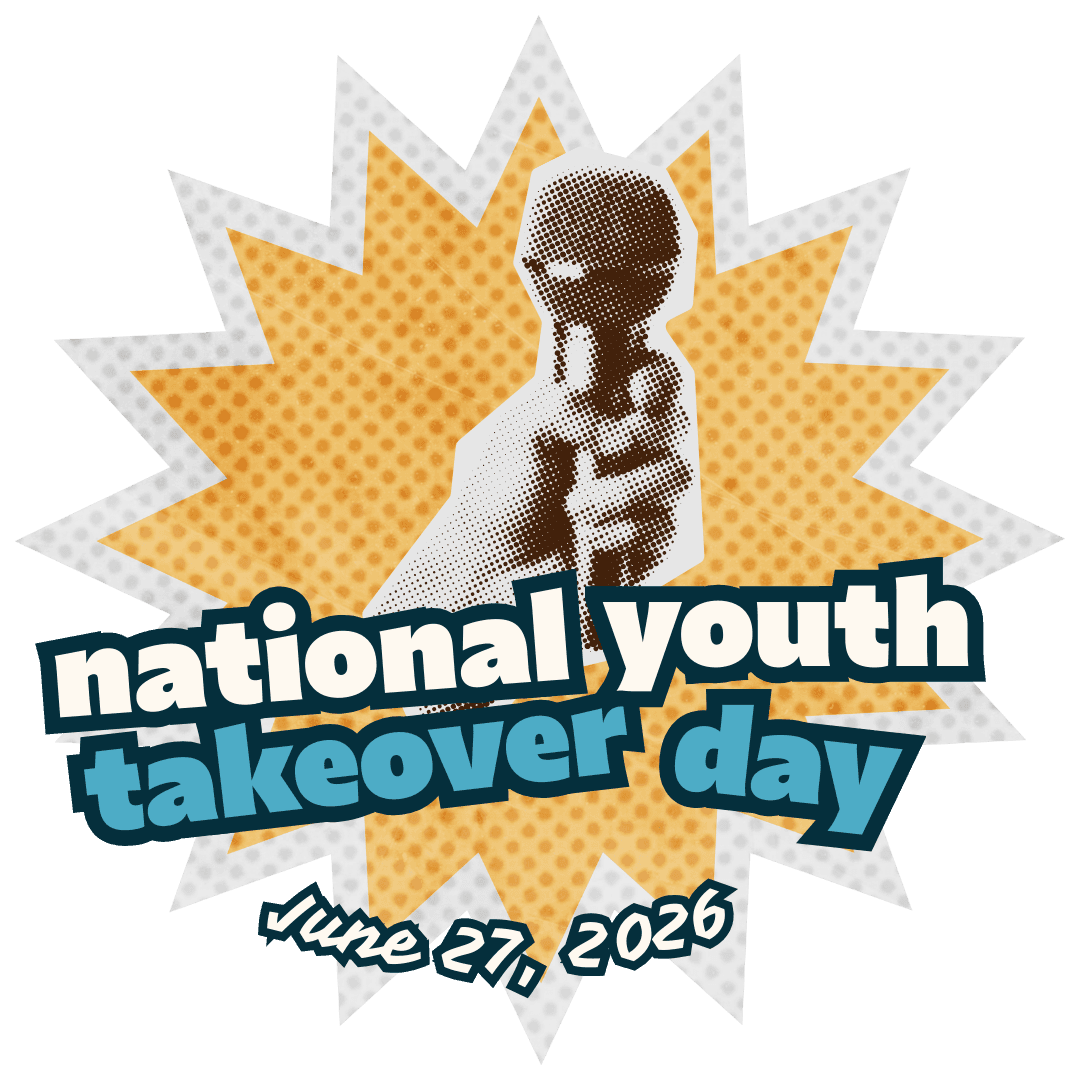 A lighthouse stands tall with an american flag.