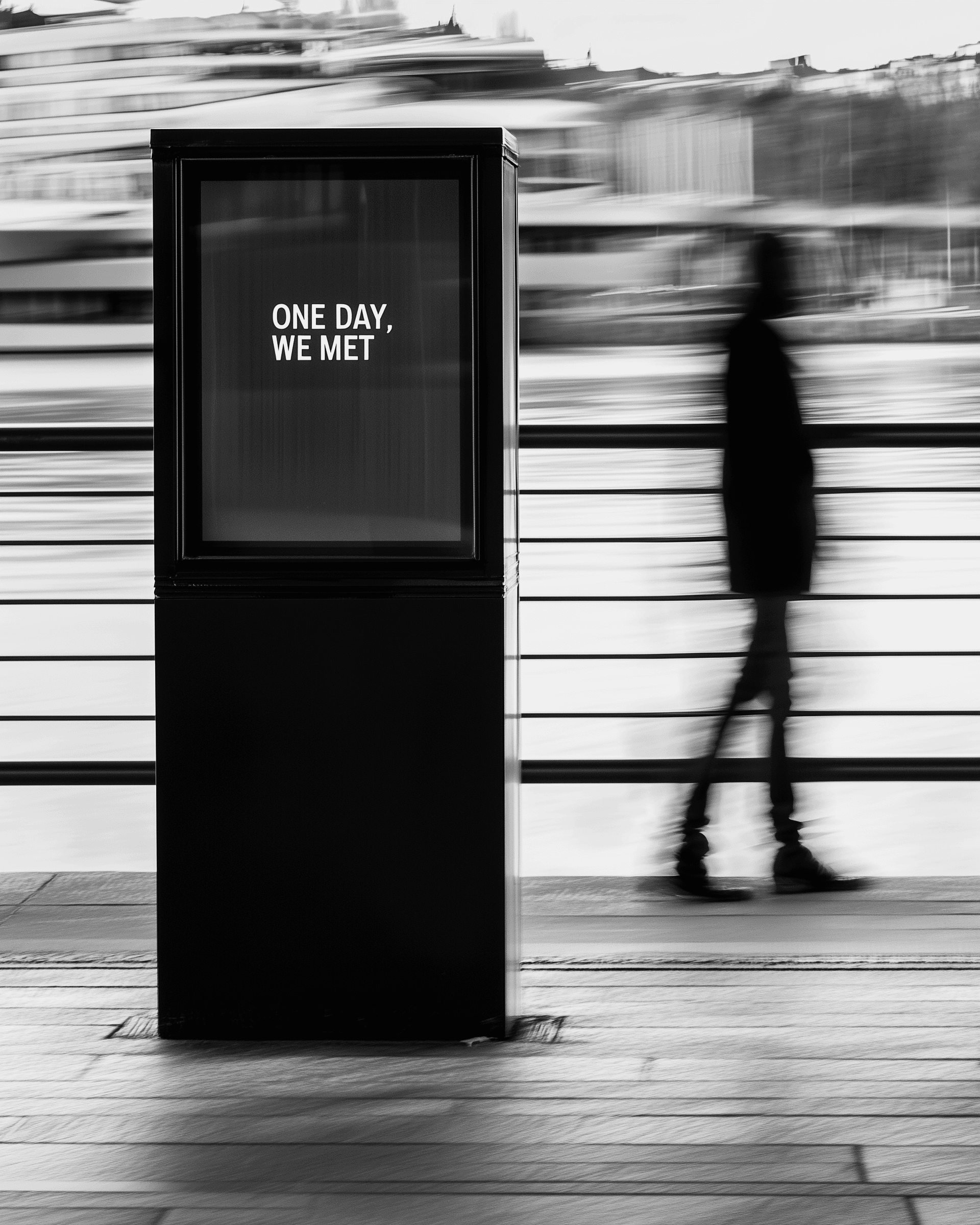 Riverfront scene with sign saying “One day, we met”