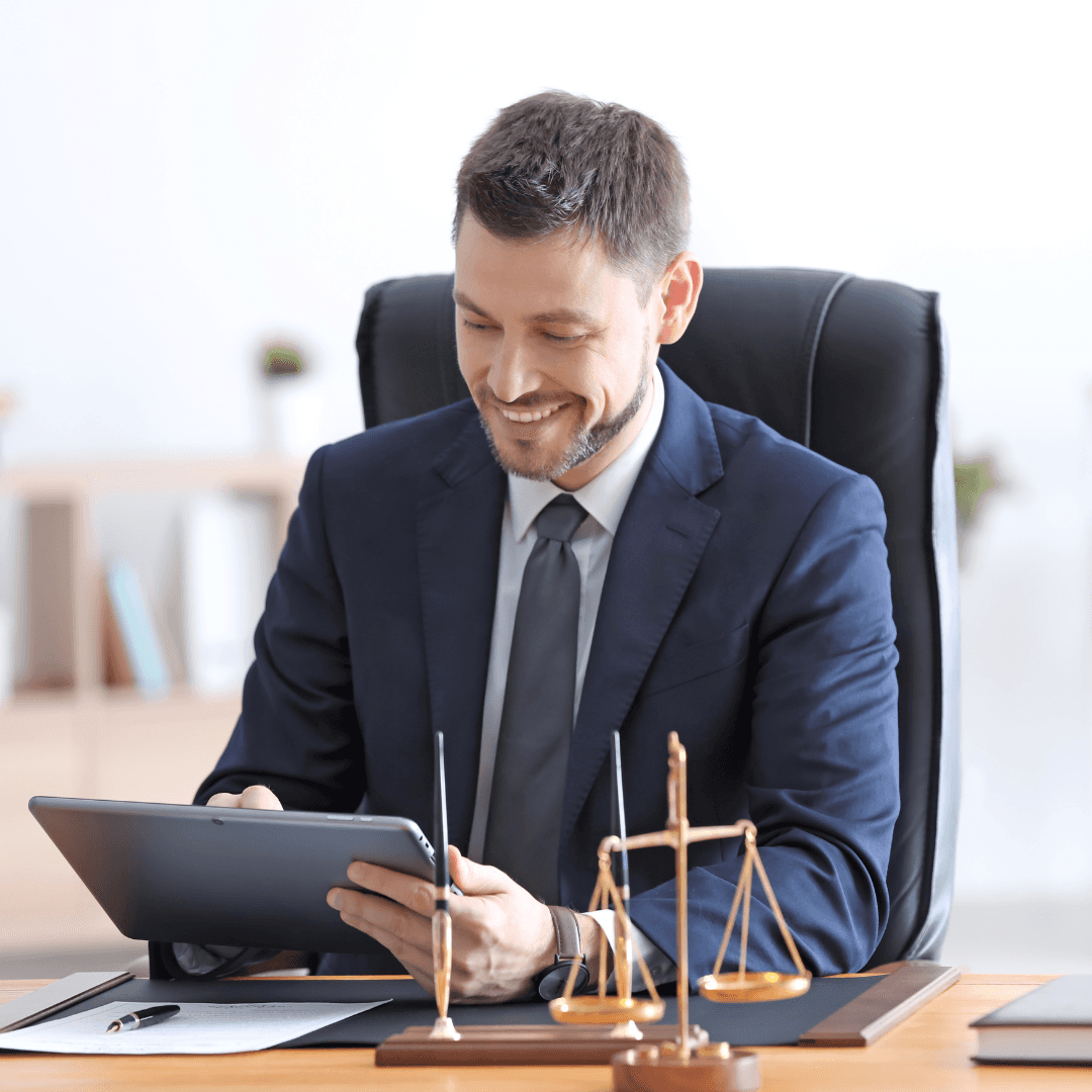 A hand holding a paper containing differnent pie charts in front of a laptop