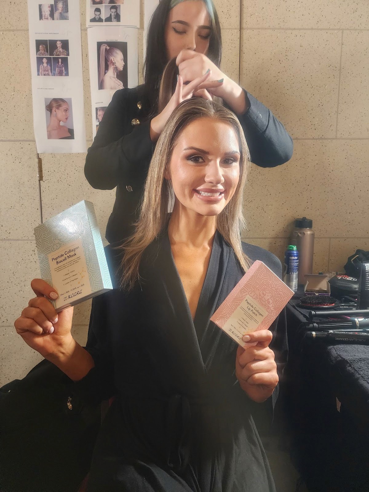  A woman receives a hair treatment from another woman, showcasing a moment of beauty care and personal grooming.
