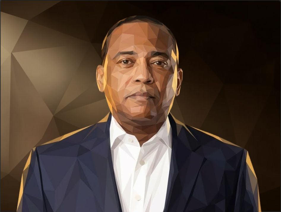A person in a suit with glasses standing against the background.