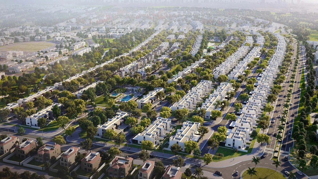 Aerial view of Villanova Dubai, showcasing modern residential buildings and lush green spaces under a clear blue sky.
