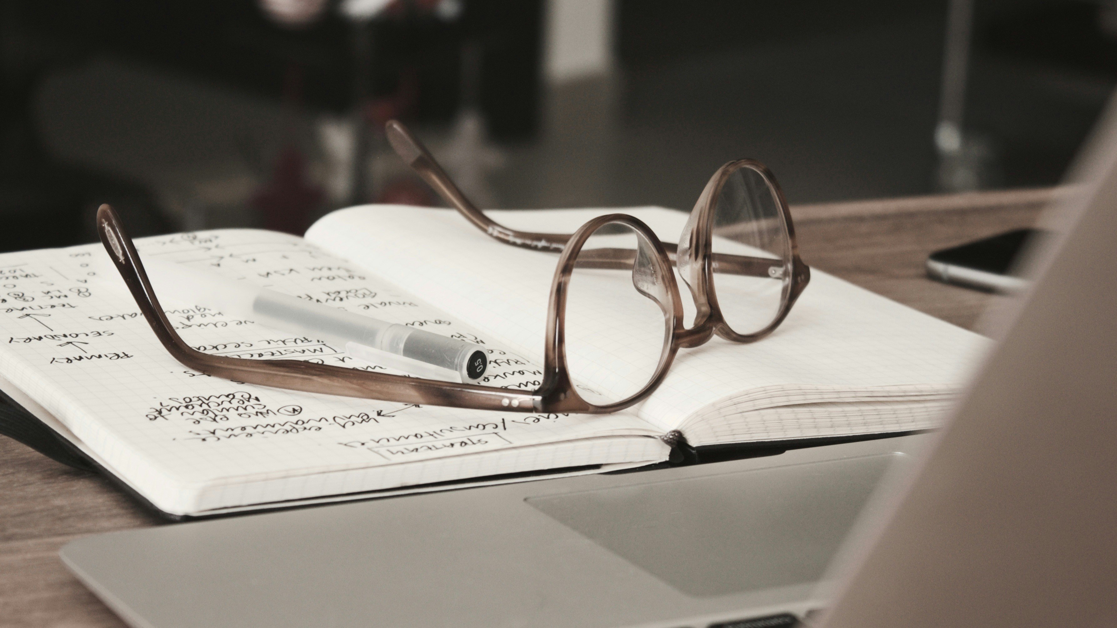 Glasses and notebook Laying - ChatGPT For Research Papers