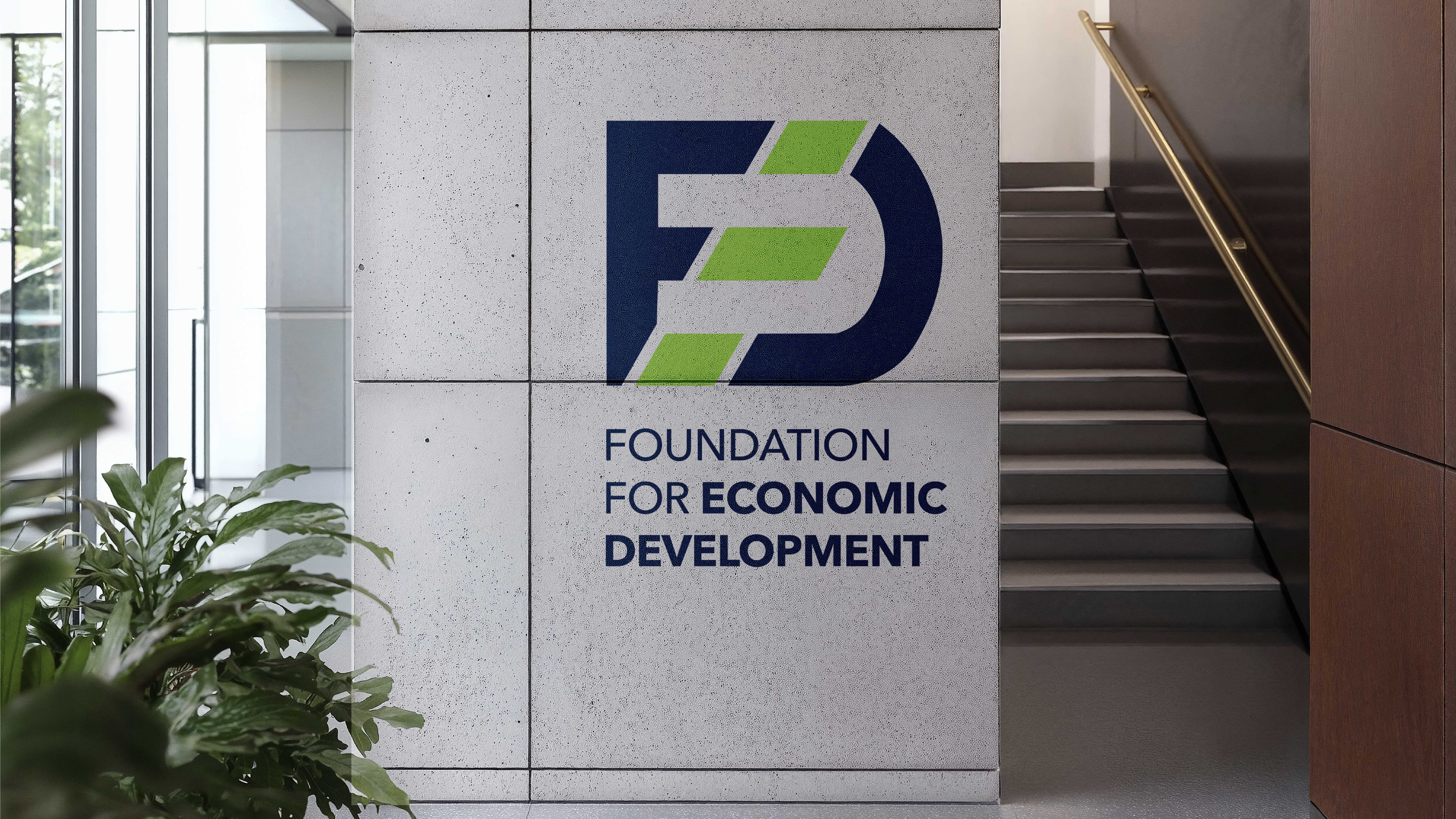 The Foundation’s brand mark is showcased on an interior stone wall in this bold office signage designed by Manasi Doshi, offering a modern yet institutional visual identity.