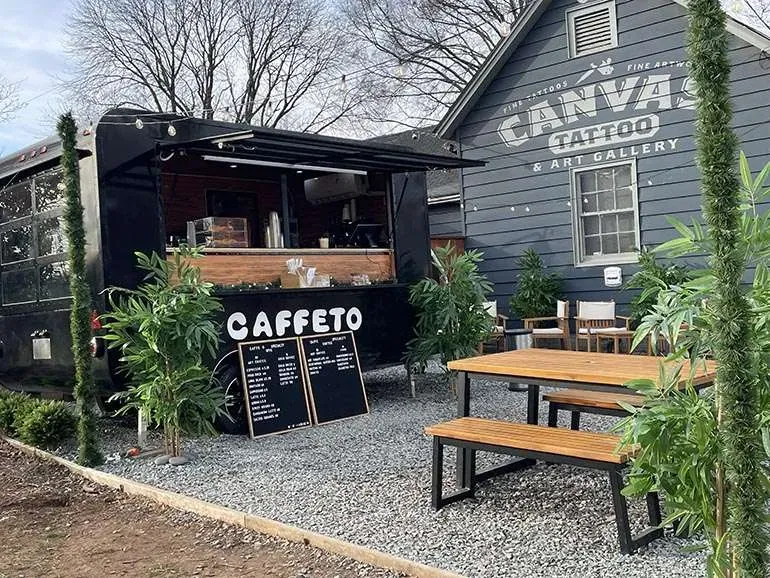 A cafe with an open sign prominently displayed, indicating that it is ready for customers.