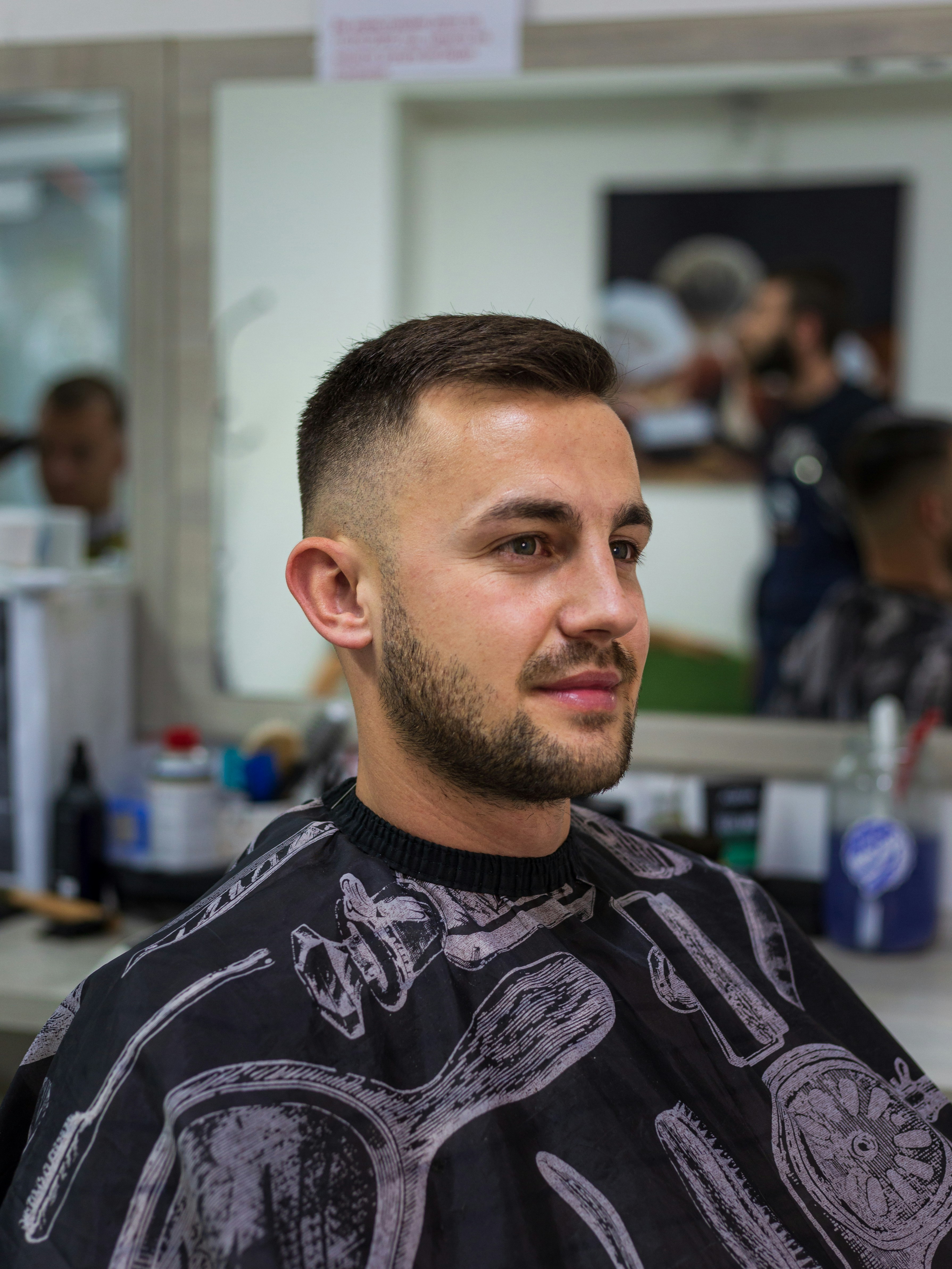a man in a barber shop getting his hair cut