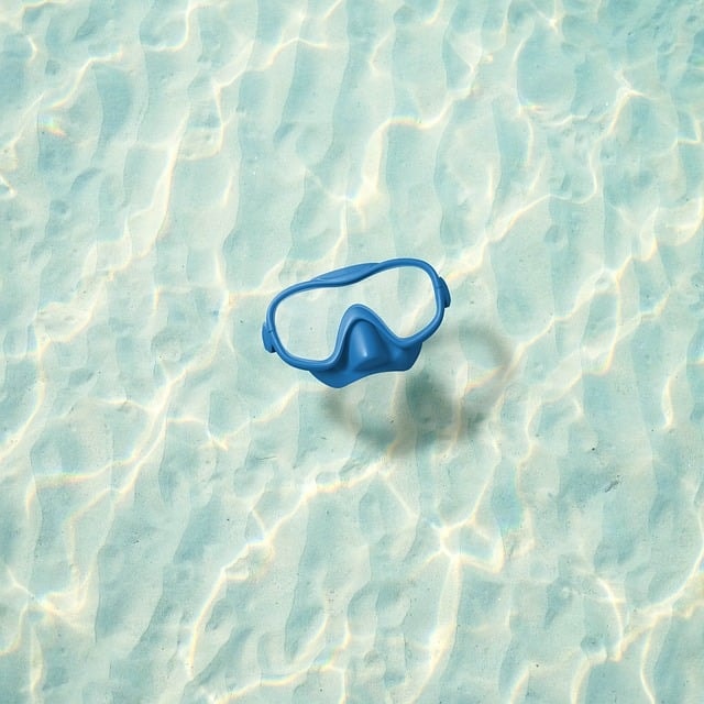 Snorkling mask floating in clear water