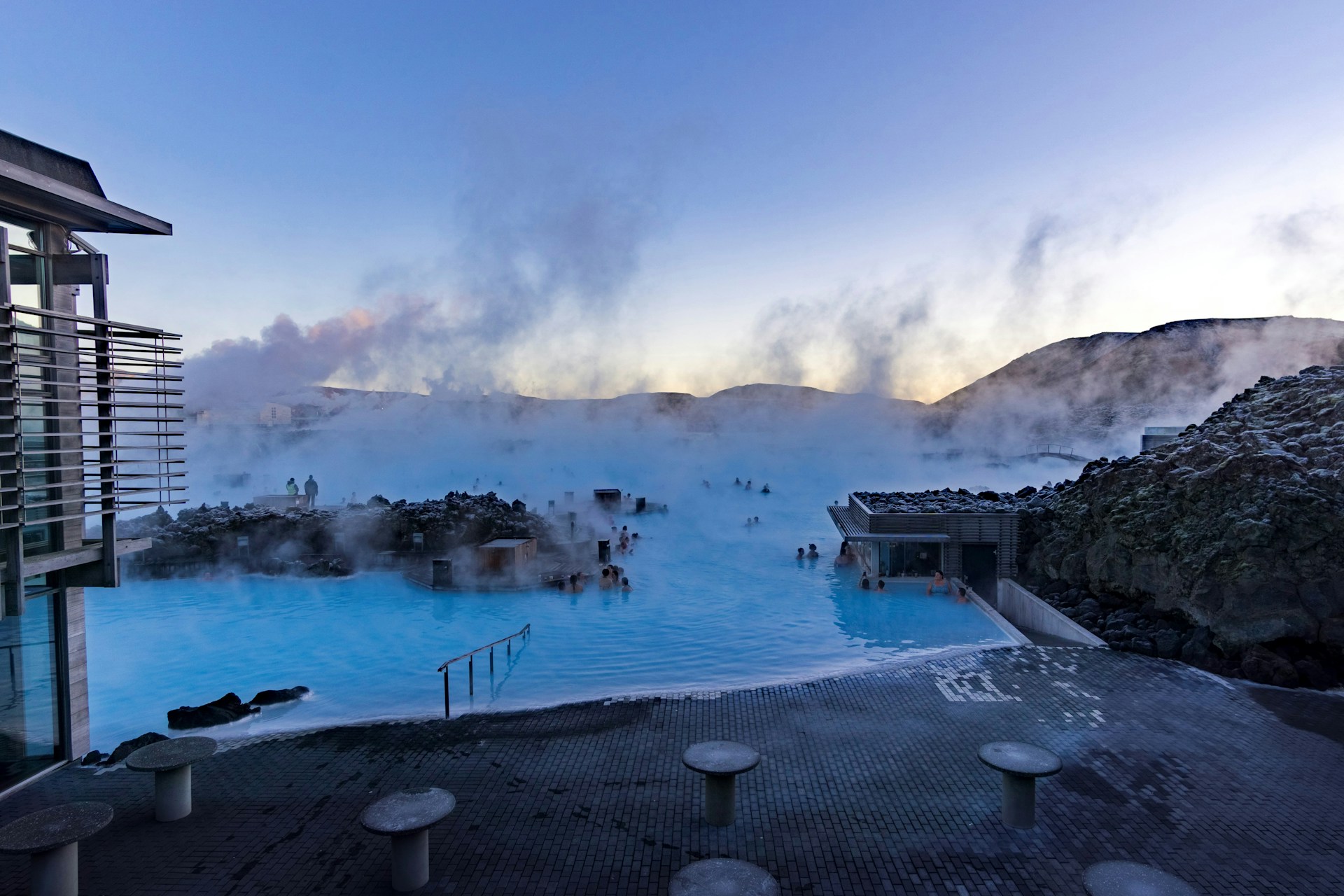 The Blue Lagoon in Iceland features warm geothermal waters surrounded by lava landscapes.