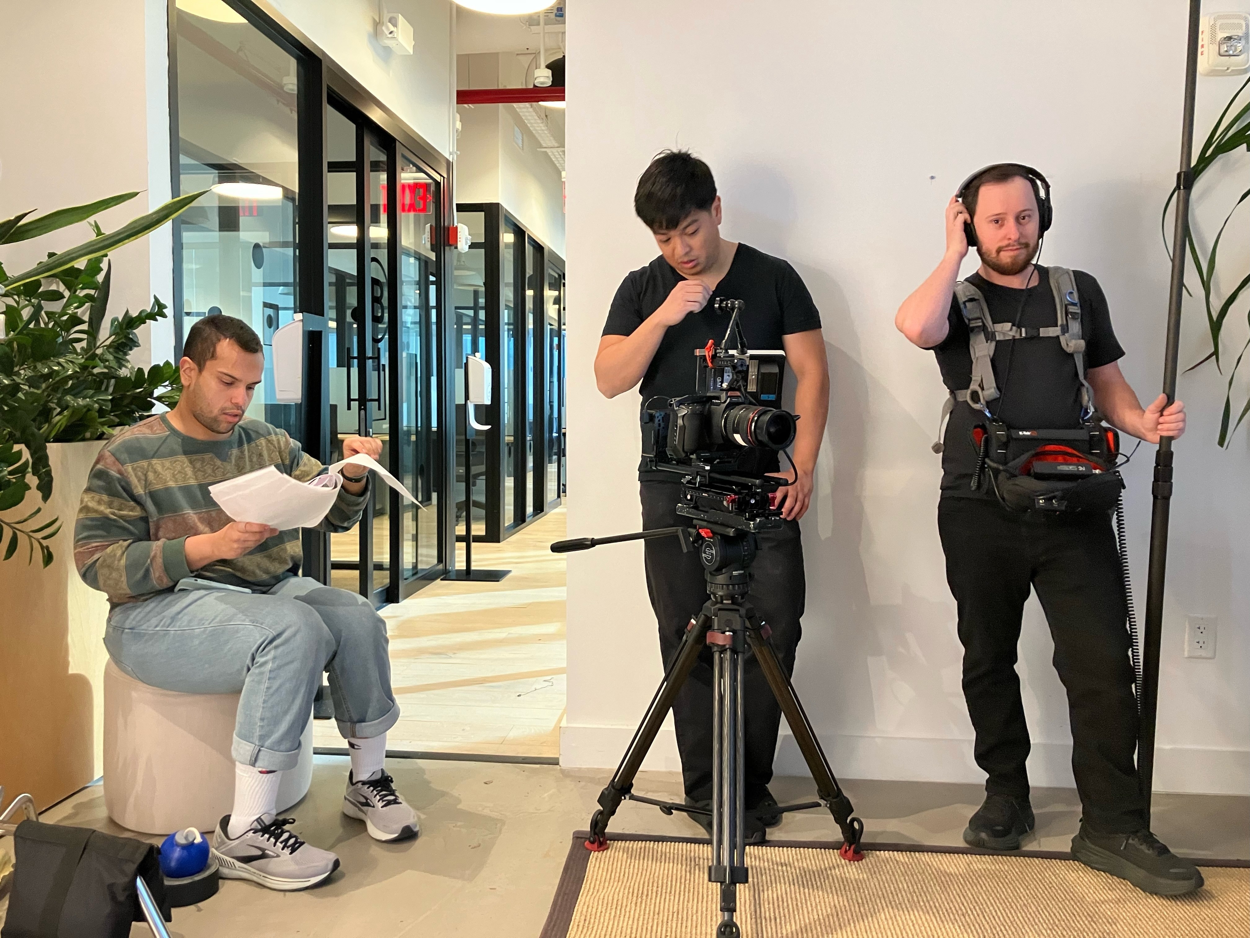 Camera and sound crew capturing a hallway scene