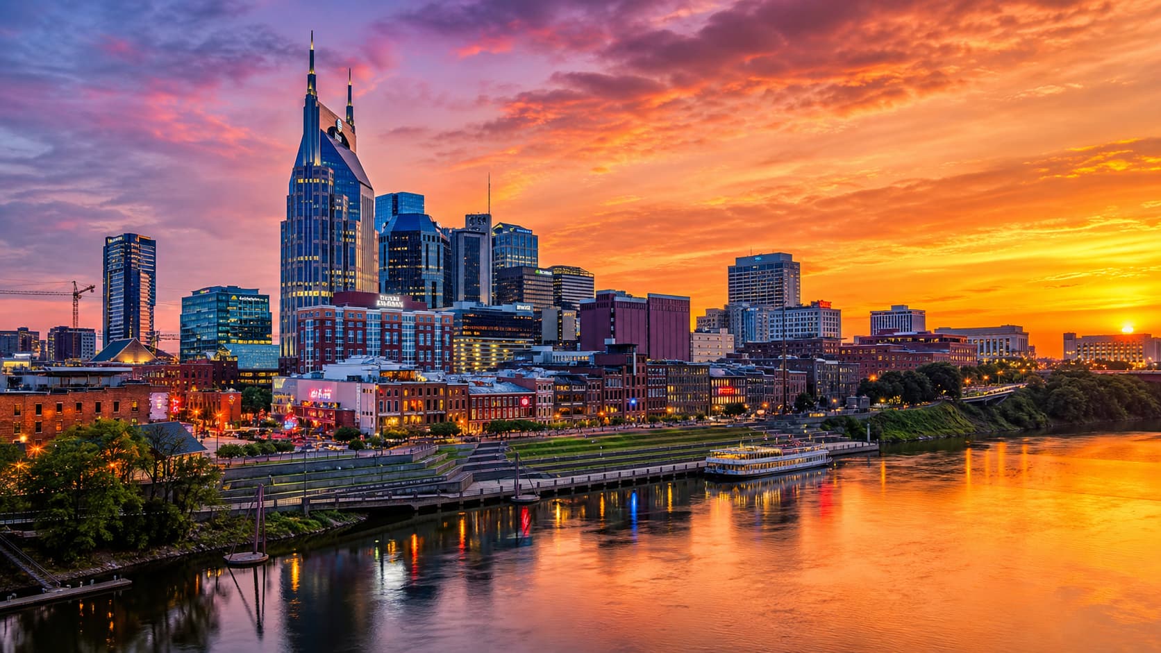 Nashville skyline with river and modern buildings at sunset