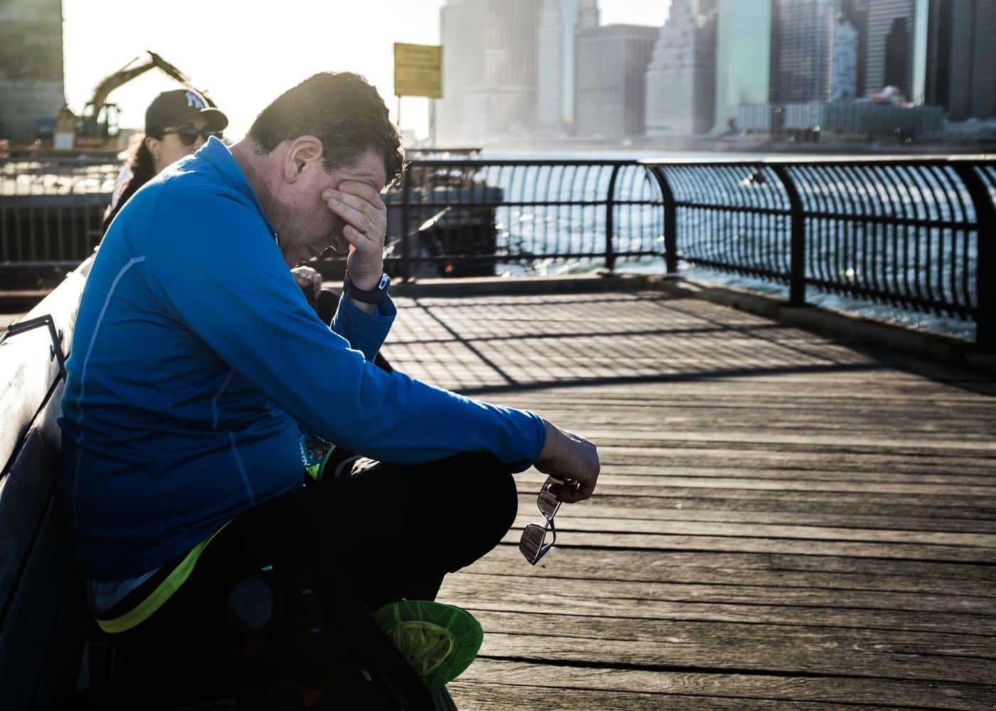 Signs of poor nutrition - Man sitting on bench holding his head in his hand