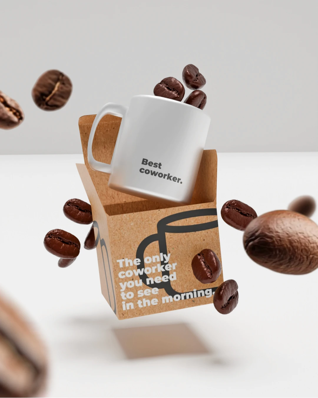 Shooting produit 3D mug "Best coworker" sortant de son packaging kraft en lévitation entouré de grains de café — branding produit du quotidien, modélisation 3D sans studio, Tartelette Concept Toulouse