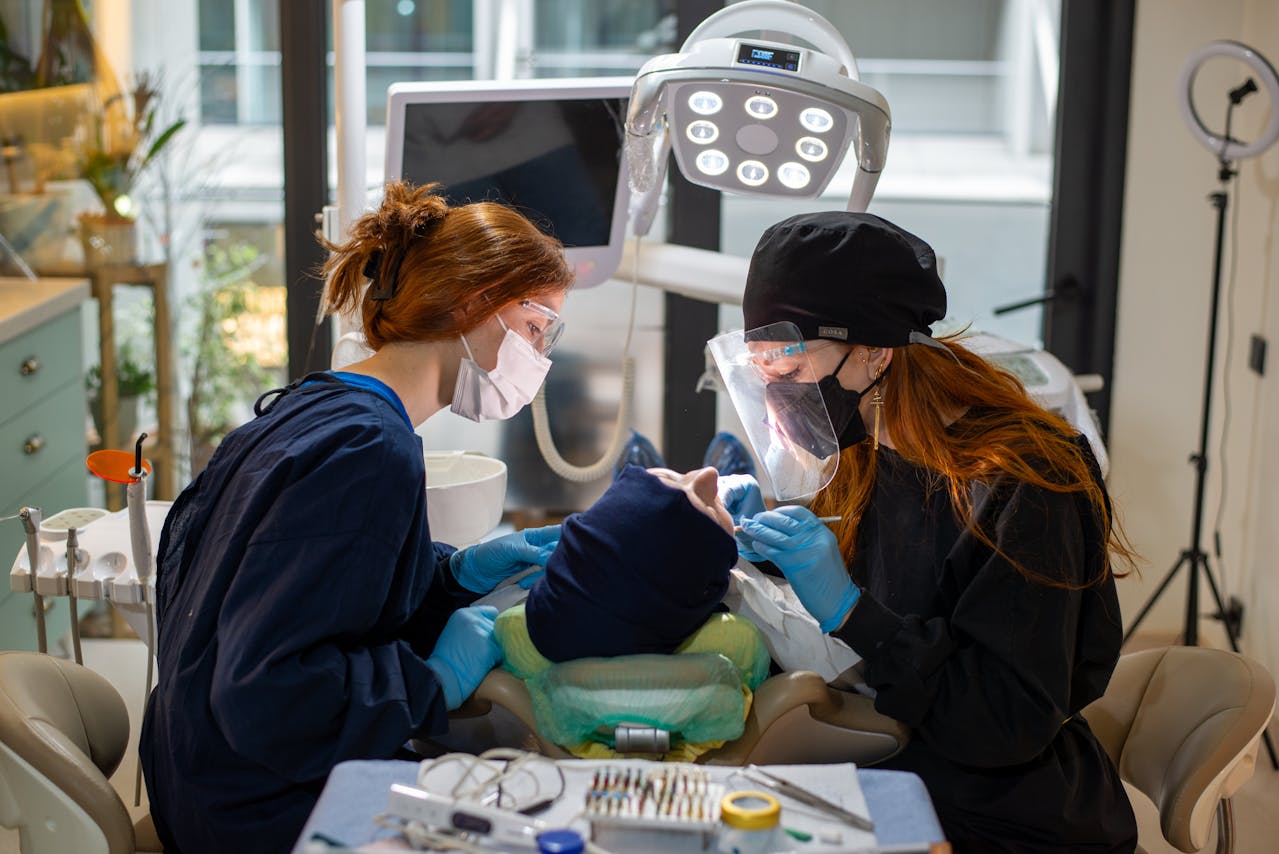 A dental assistant helping the dentist