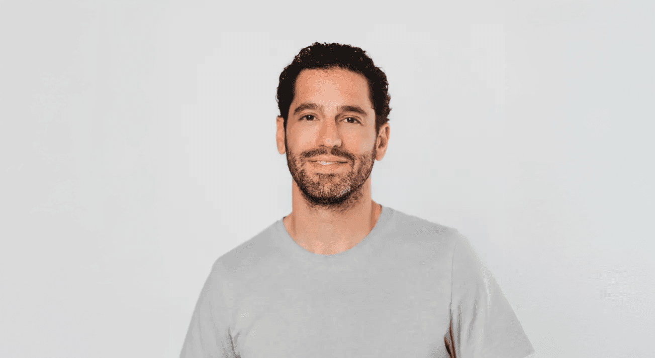 Man in gray t-shirt smiling at camera