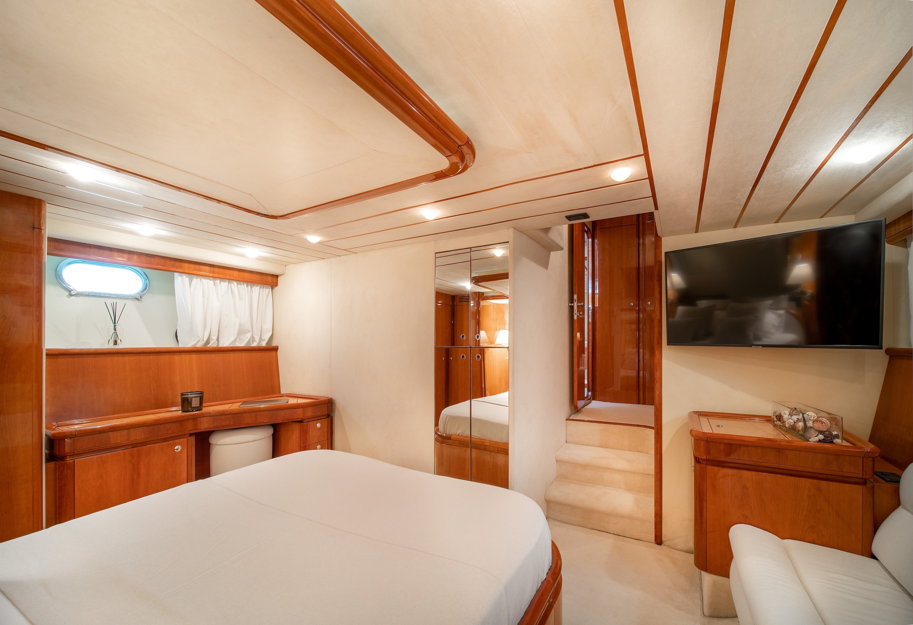 White Rock 36 speedboat with captain at helm cruising calm blue waters near Paros coastline with hills in background.
