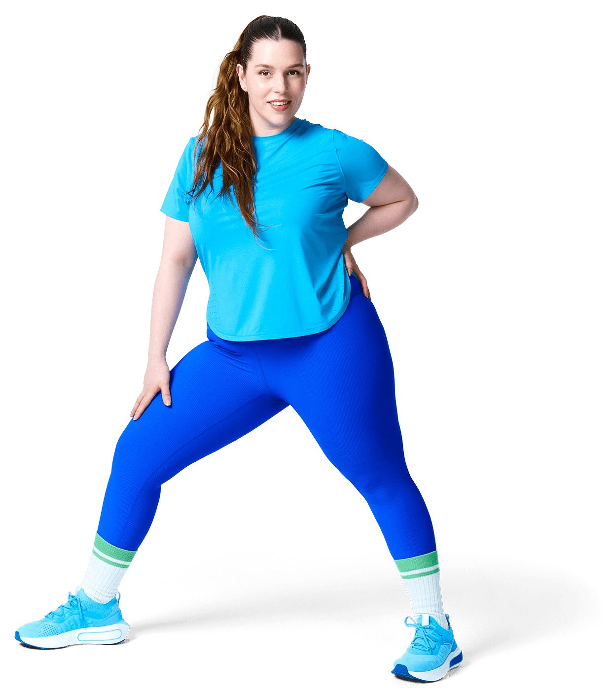 A person in sportswear is lifting one knee while standing on one leg, showcasing a workout or stretching activity.