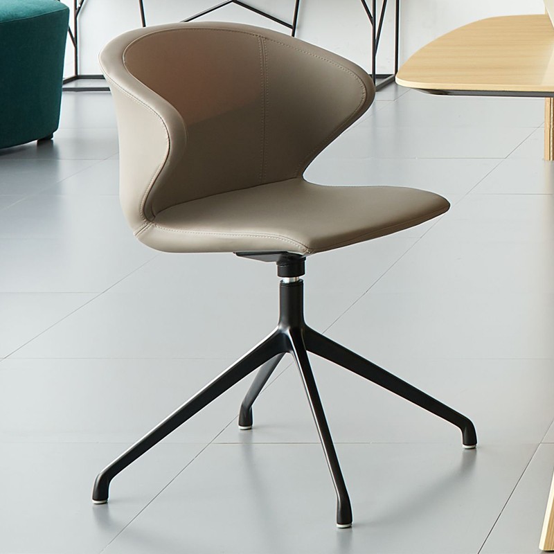 Modern taupe leather swivel office chair with a curved ergonomic backrest and a four-star matte black metal base, shown in a contemporary office setting.