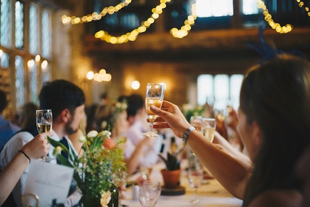 Holding up a glass of champagne at an event