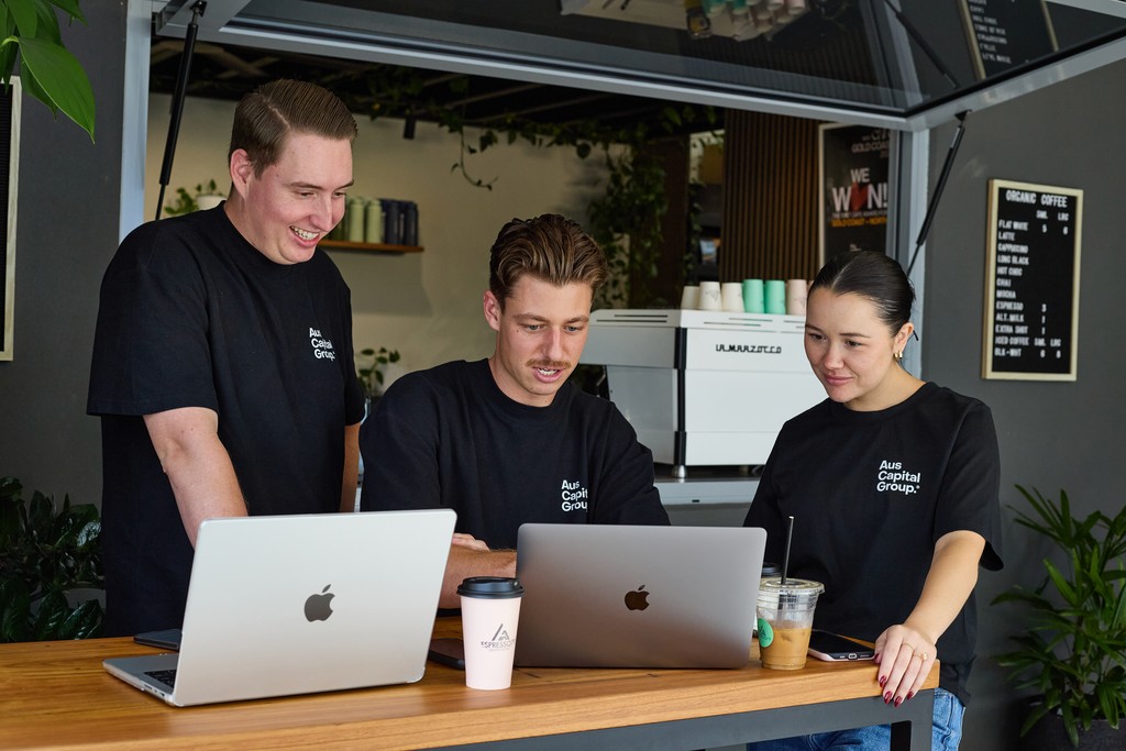 The team working together at a table with laptops, discussing business strategies or projects.
