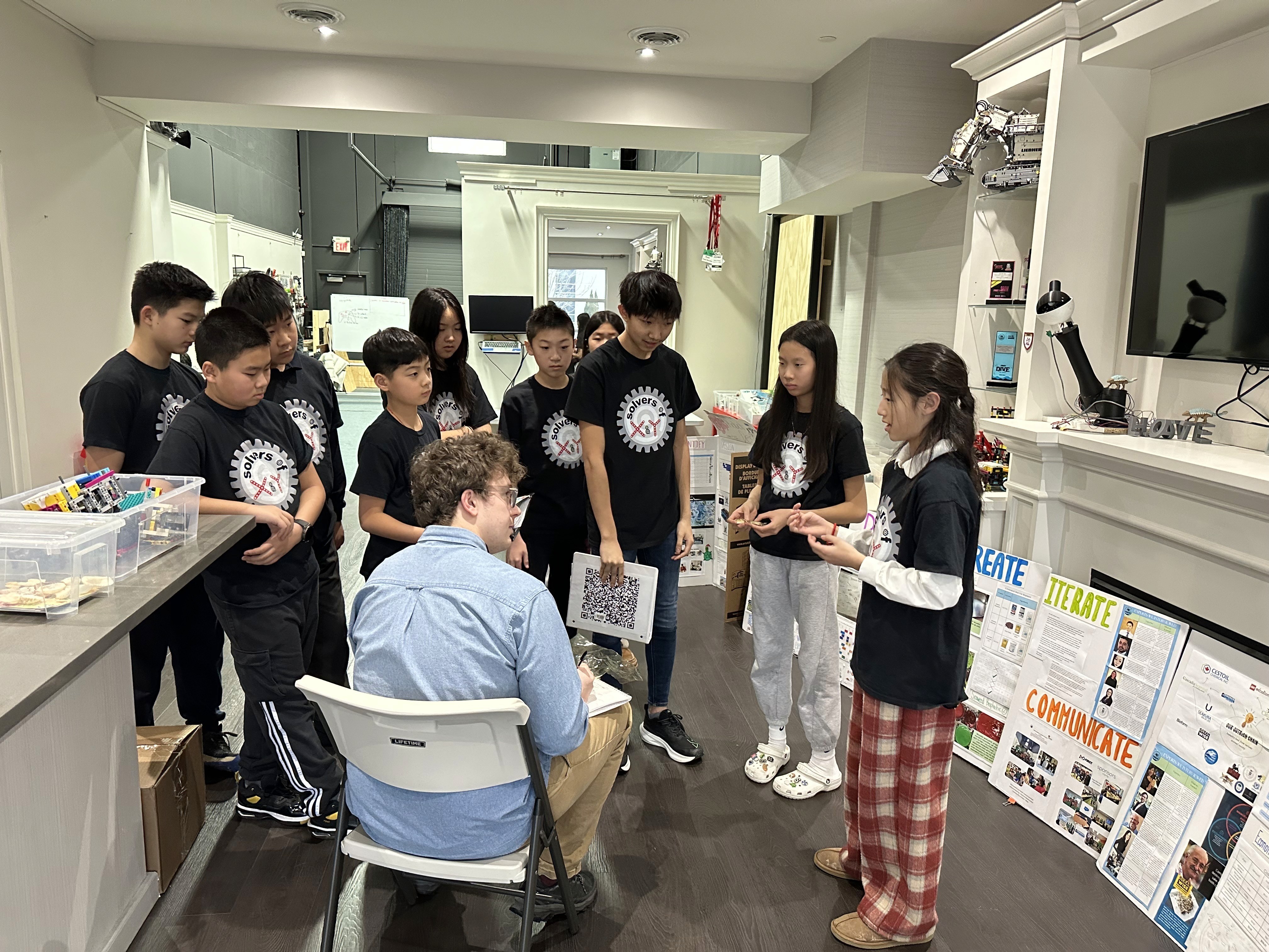 Renee Zhang from Solvers of X & Y explains the team's innovation project to Bailey Moreton