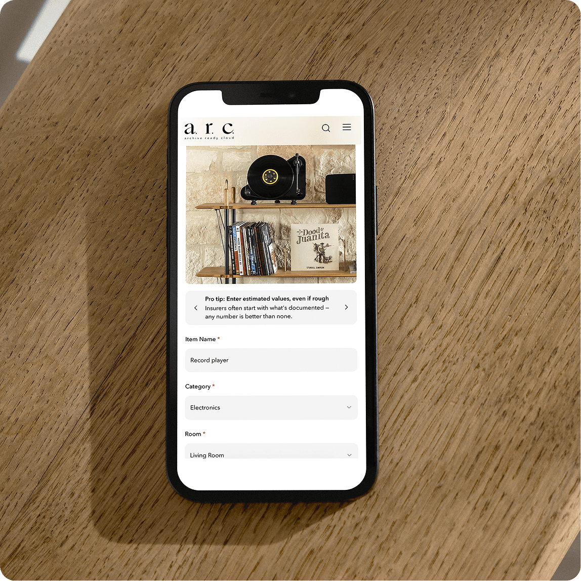 Rustic modern hill country living room with natural stone fireplace, wooden ceiling, mid-century chairs and area rug
