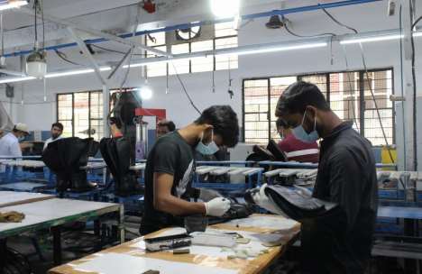 People working on belt production in factory 