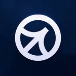 A person with short, curly blond hair wears a bright orange turtleneck sweater. The background is plain, creating a calm and focused portrait look.