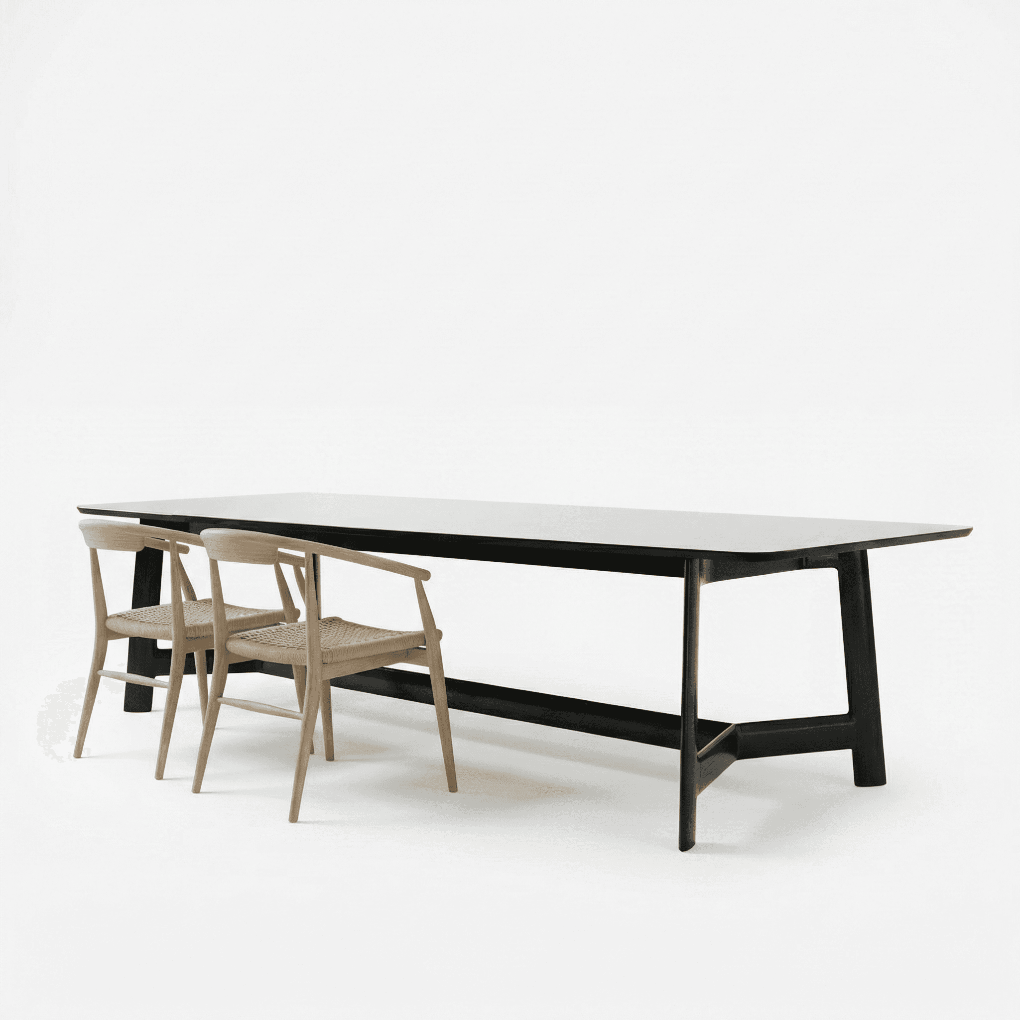 Minimal black dining table with slim profile, paired with woven wooden chairs