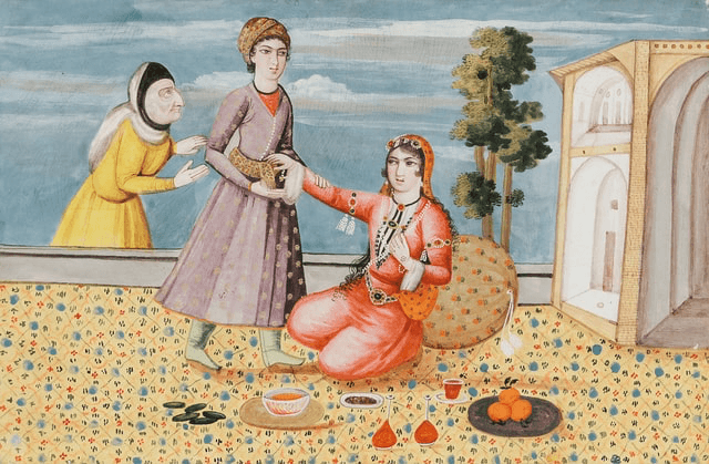 Two women interact, one seated and receiving food, while another stands nearby, with a scenic backdrop.