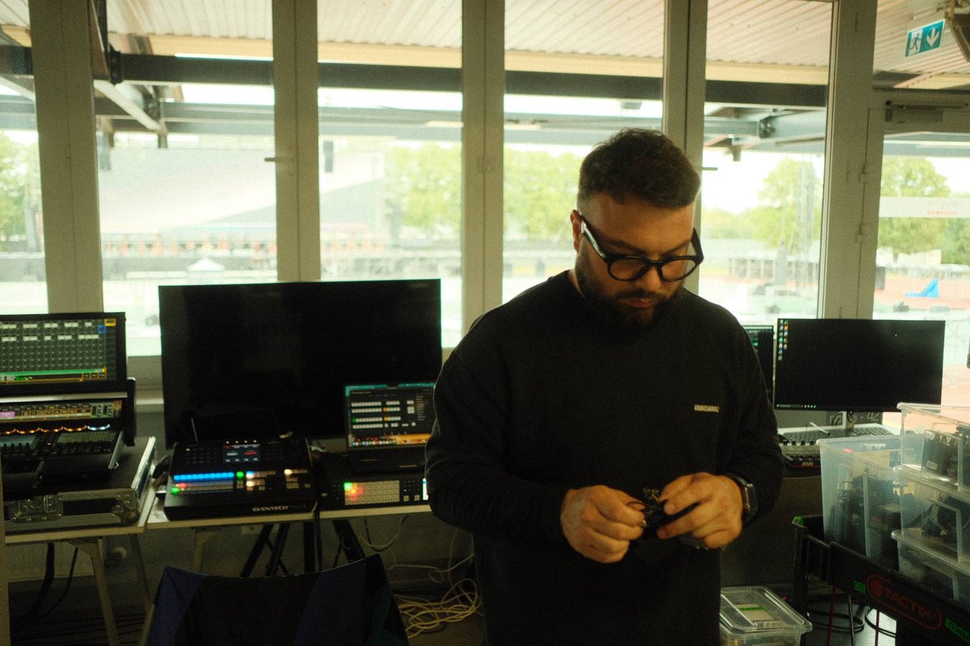 Crew member preparing equipment in the video control room