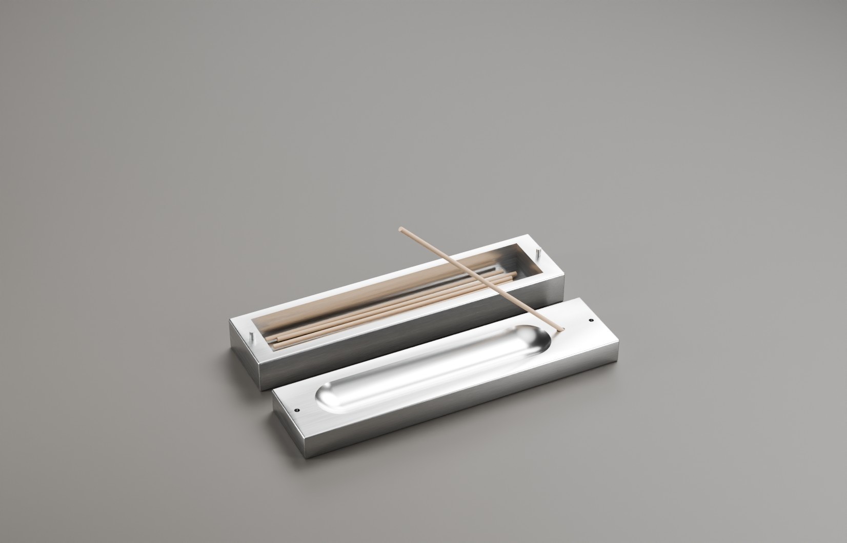 Open metal incense box showing a reversible lid and incense sticks