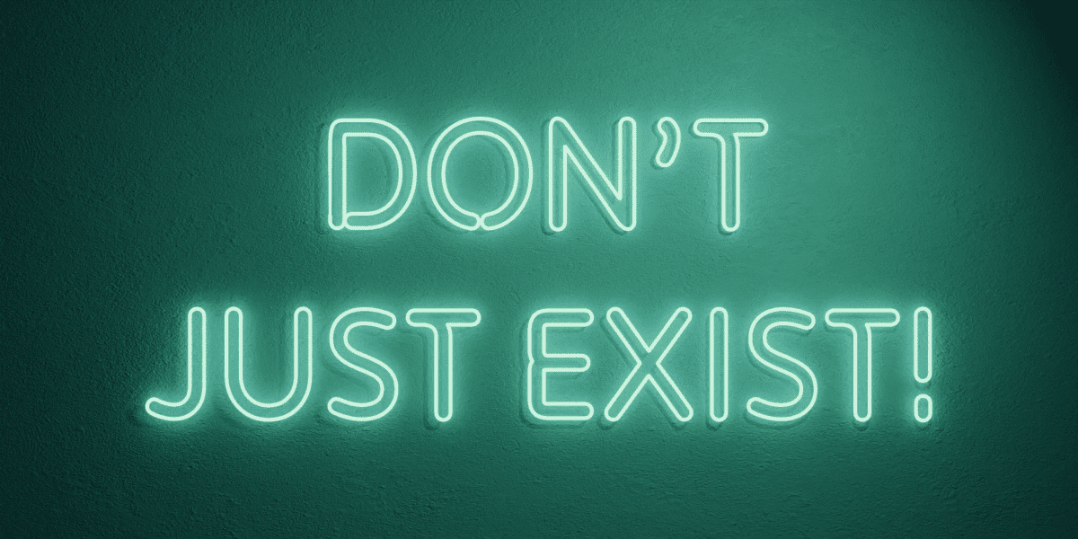 Neon sign saying DON'T JUST EXIST