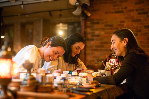 A group of participants smiling and enjoying the creative process in a stained glass painting workshop, emphasizing the social and artistic atmosphere in Istanbul.