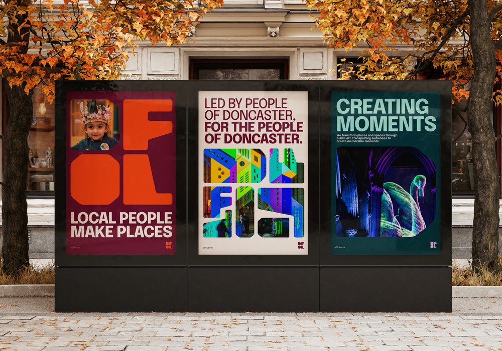 Three posters shown on a street