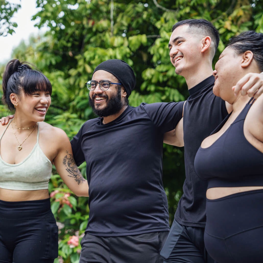 Woman smiling holding phone with provider on screen and a compounded semaglutide bottle next to her.