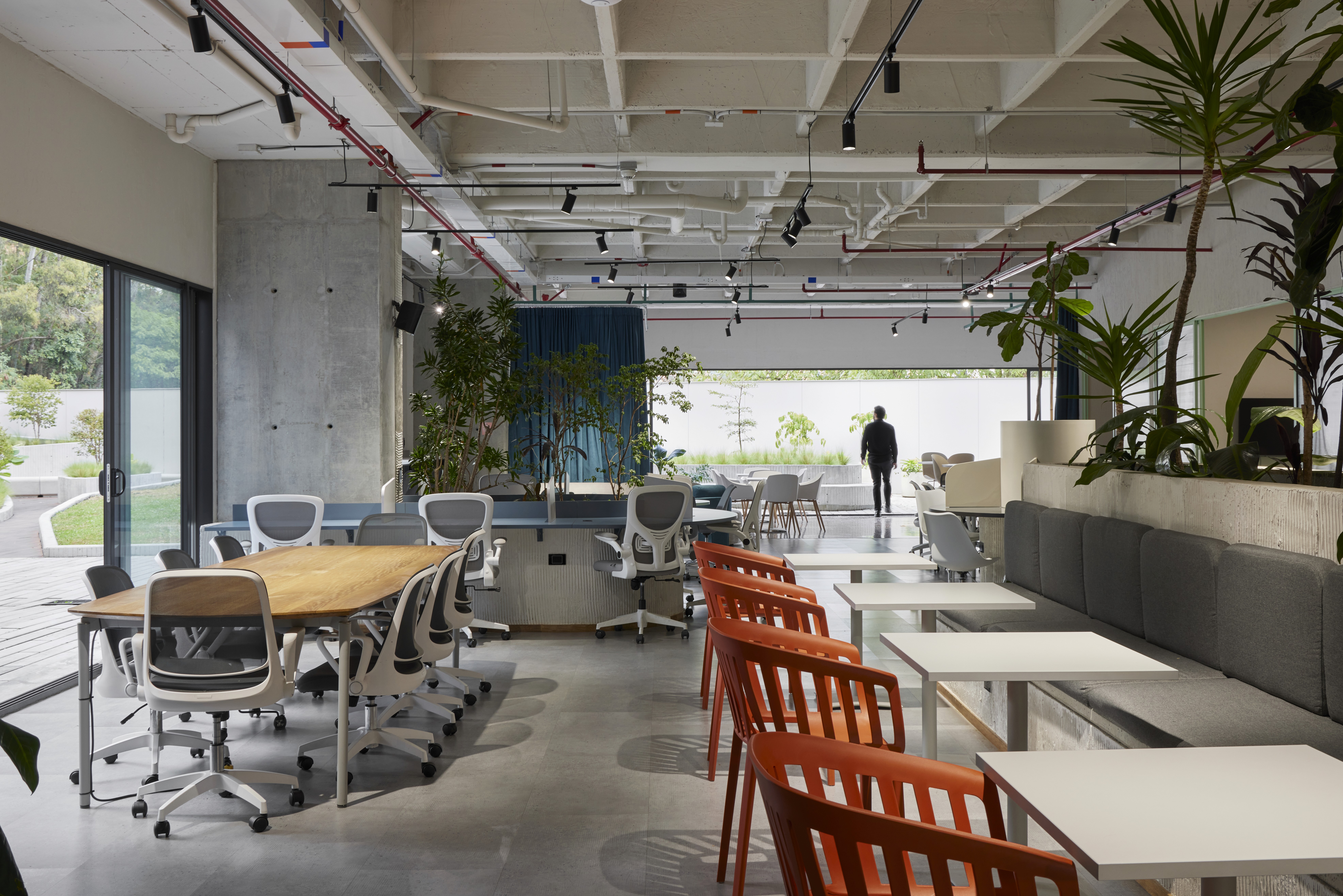 Double-height interior with flowing sculptural forms and warm raking light