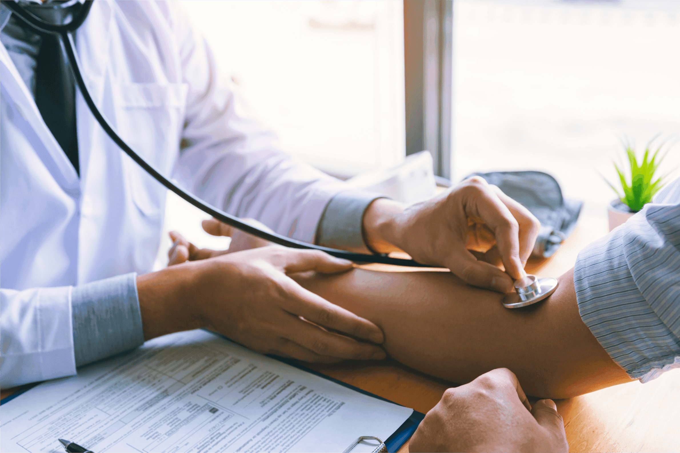 Modern kitchen with a wooden dining table, white chairs, and a hanging light fixture above.