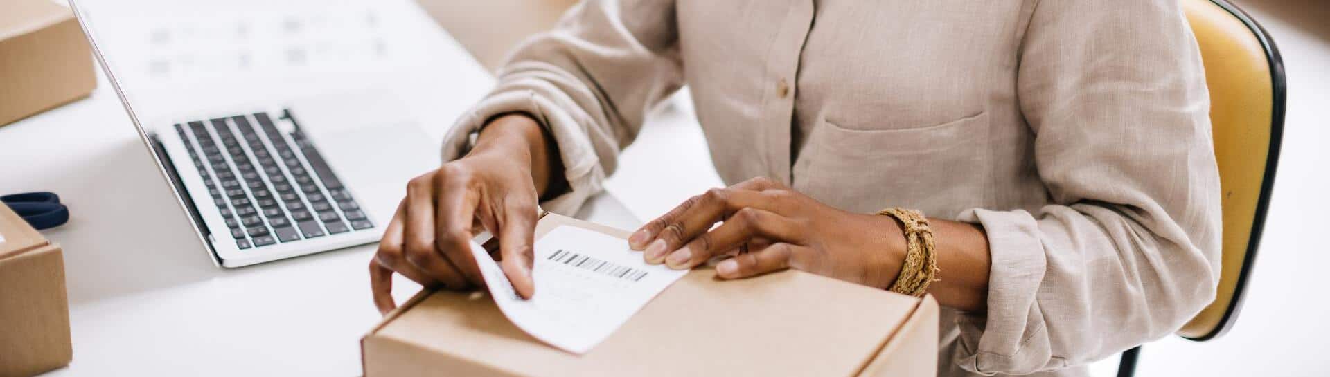 Woman confidently labeling and shipping e-commerce packages during peak season rush