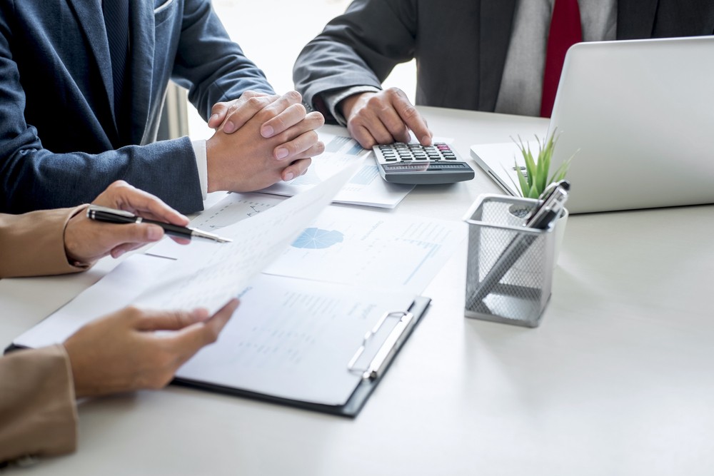 Group of partner working conversation, Business team meeting present with investor colleagues discussing plan financial graph data and analyzing strategy to growth up to profit into company