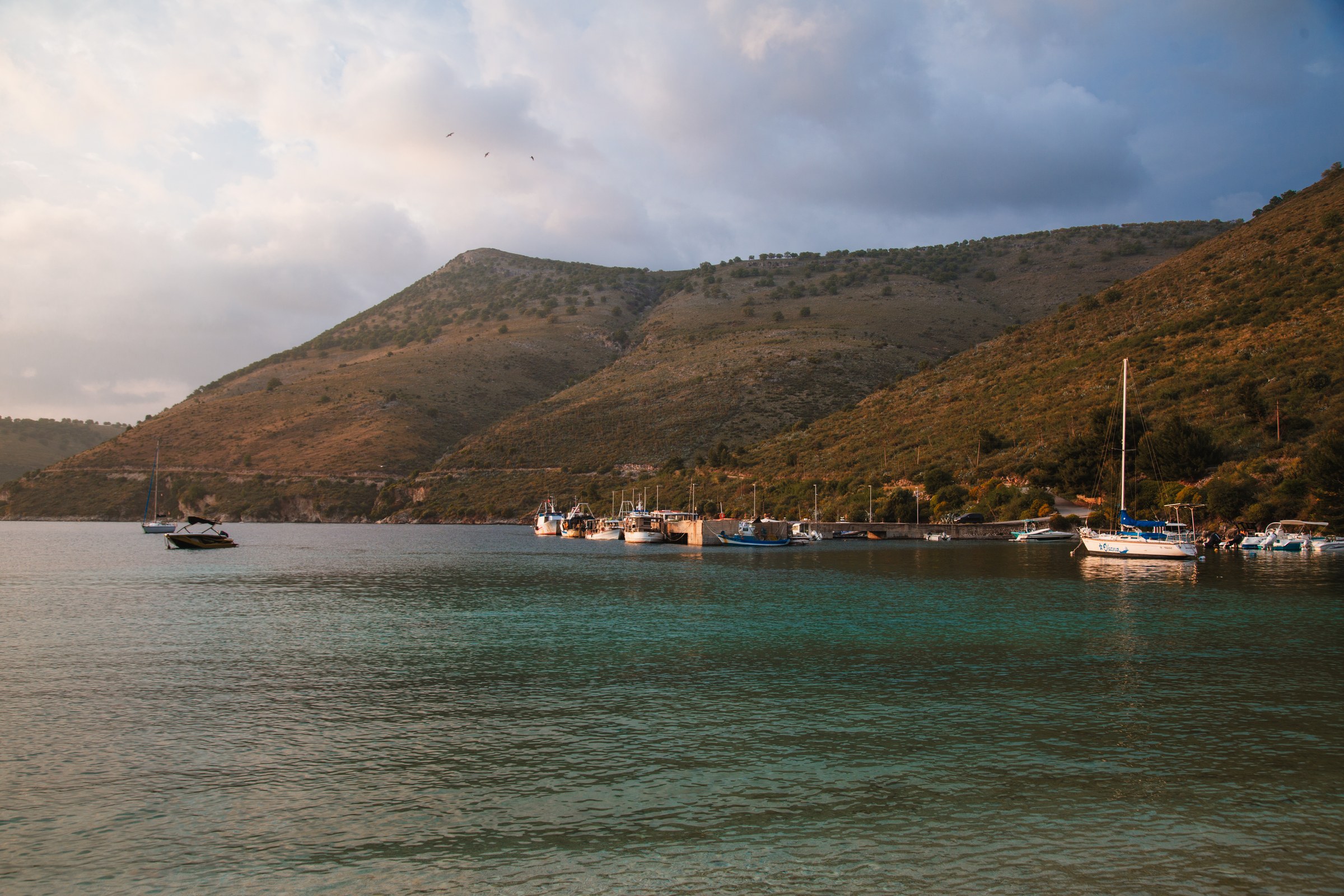 TRAVEL · A sheltered bay beneath the hills.