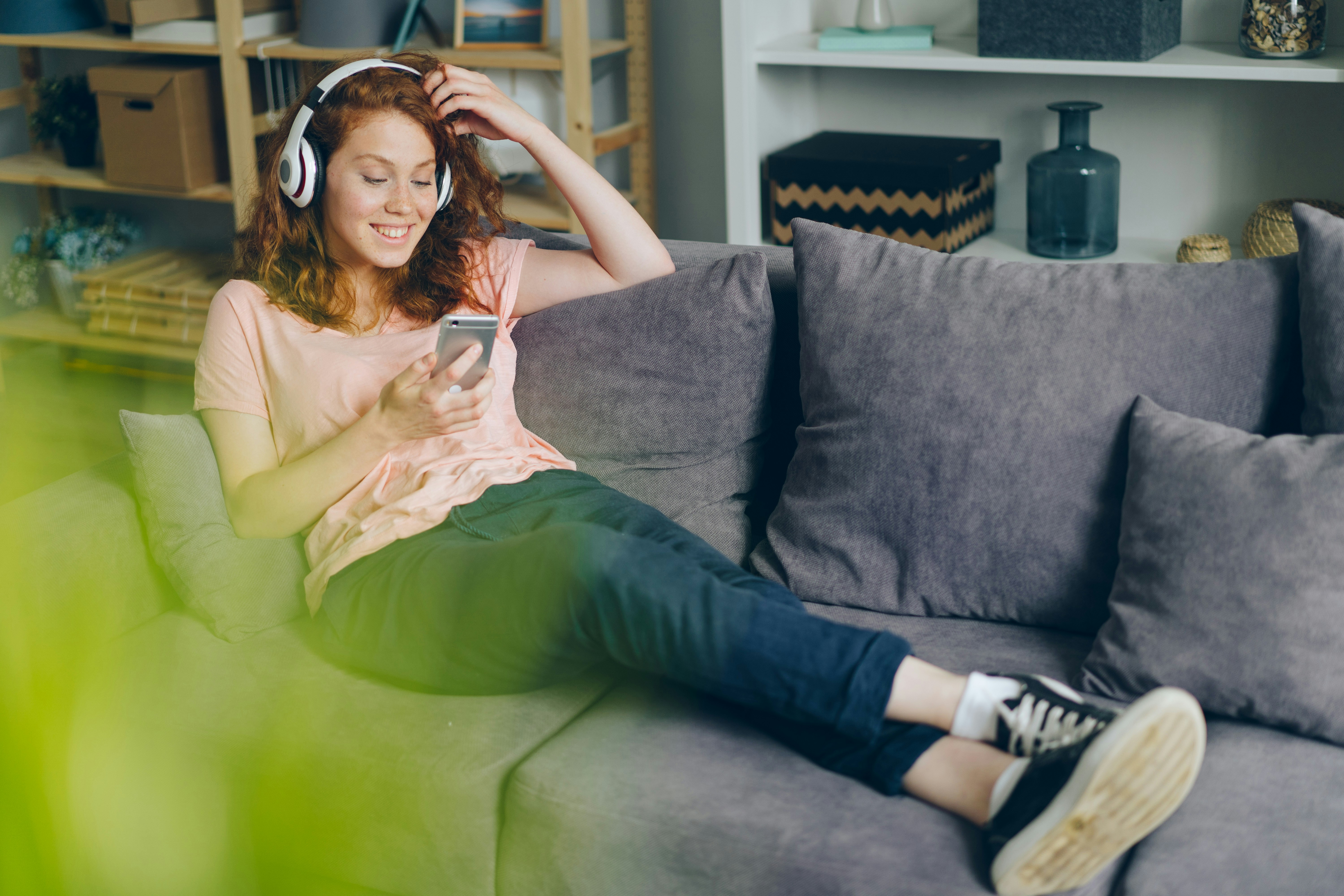 woman with headphones sitting on couch - Listening to Music Meme 