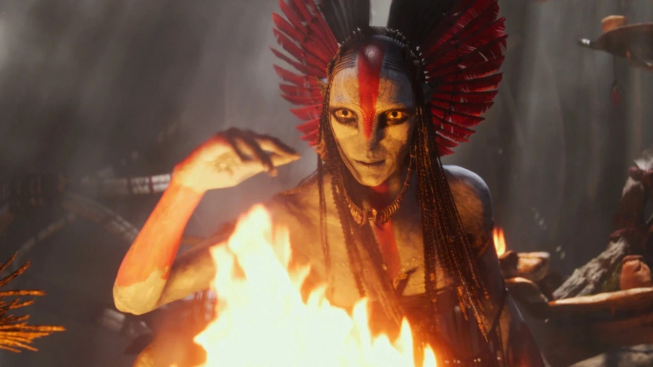 A figure with intricate body paint and vibrant red feathers in their hair, raises their hand above a bright flame, creating a dramatic and mystical atmosphere.