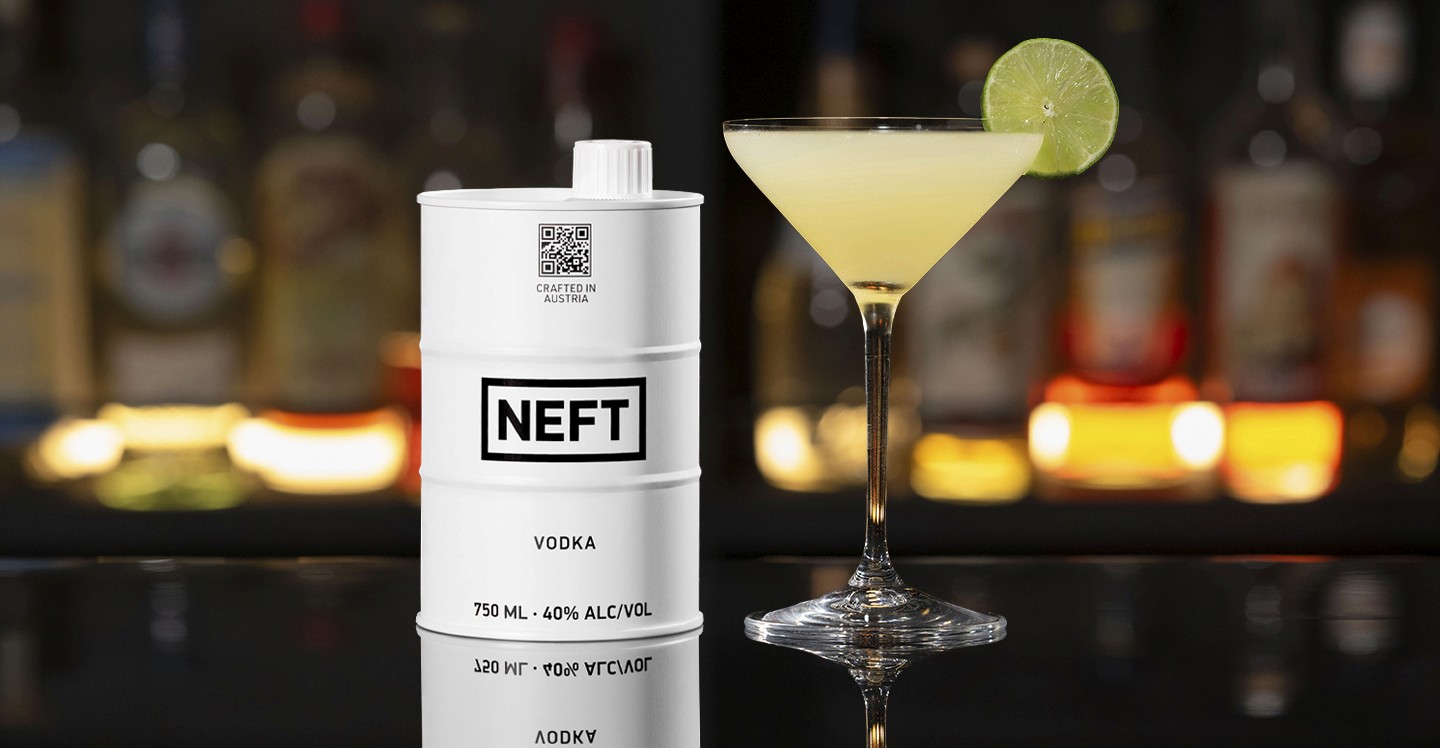 A NEFT Barrel and a glass of Kamikaze on a bar counter.