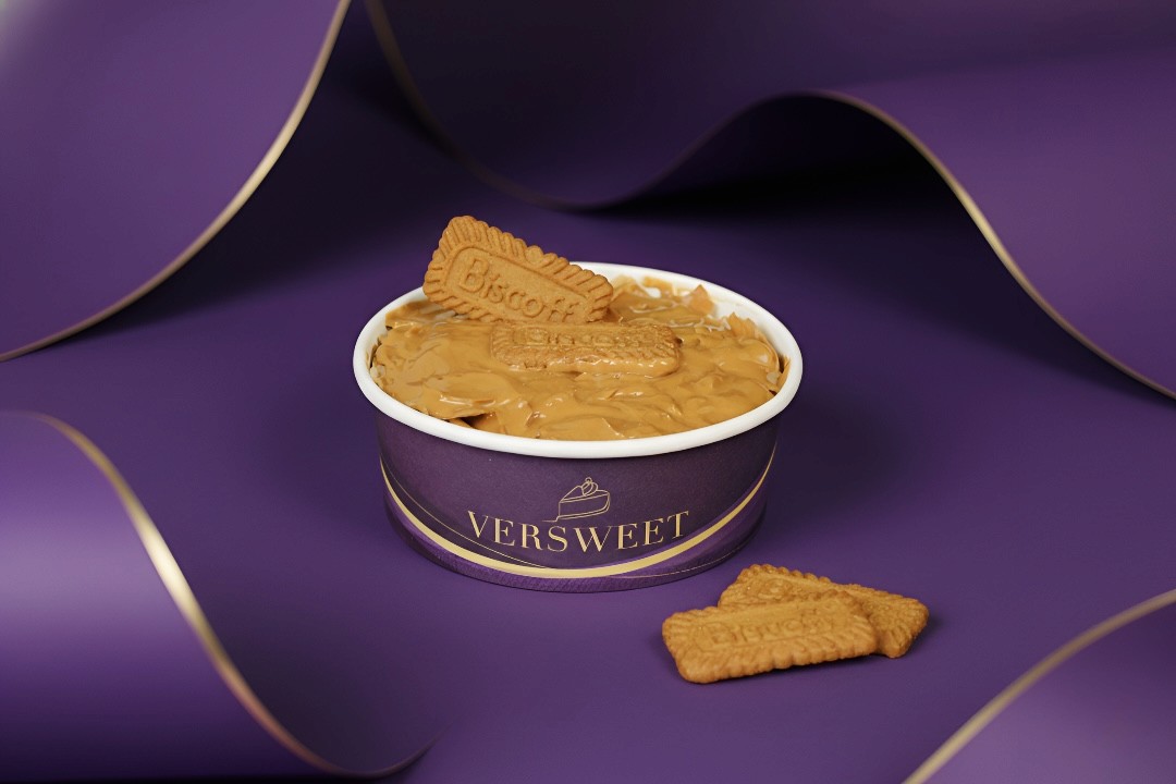 Milk being poured into black coffee in white cup